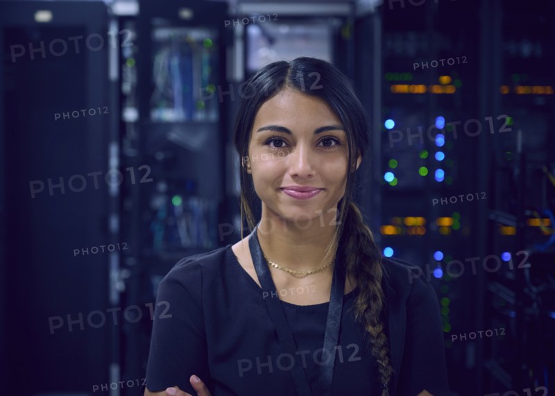 Portrait of smiling female technician in server room