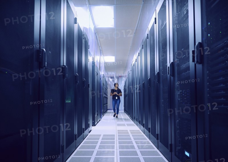 Female technician walking in server room