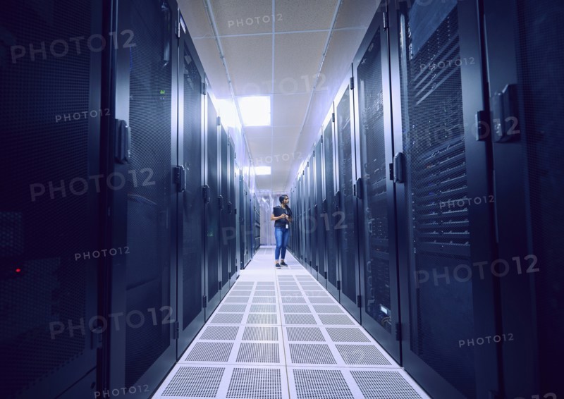 Female technician working in server room