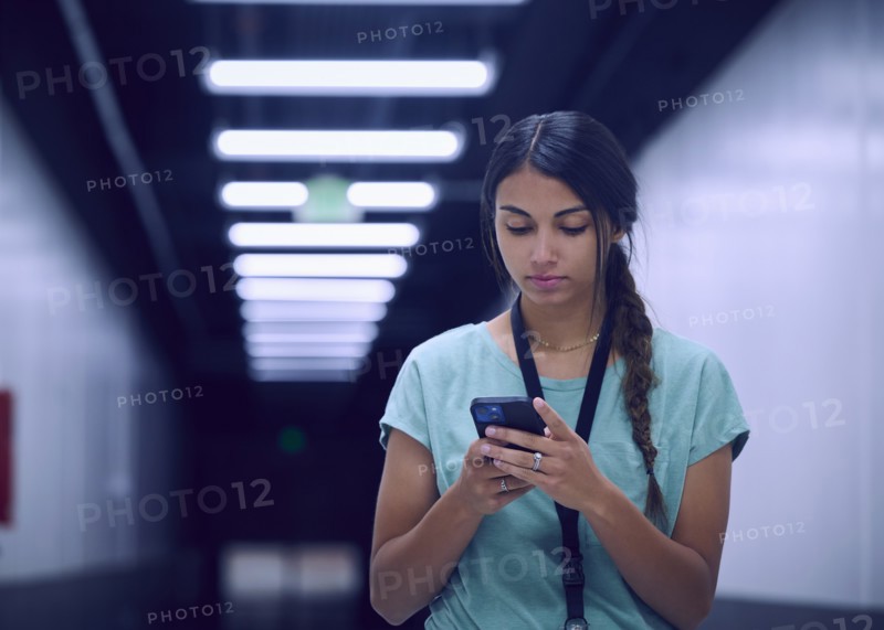 Female technician looking at smart phone