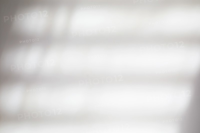 Shadows of blinds on white wall