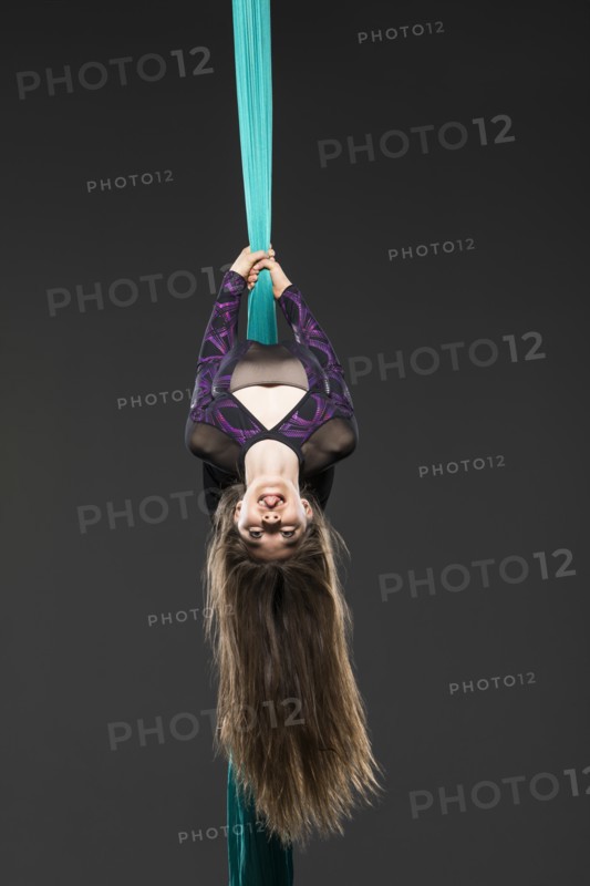 Teenage girl (14-15) during aerial silk practice