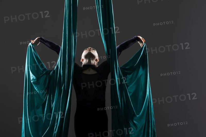 Teenage girl (14-15) practicing aerial silk
