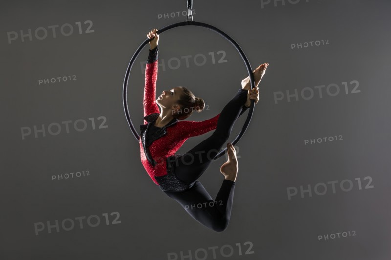 Teenage aerialist (14-15) practising on gymnastic hoop