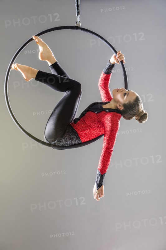 Teenage girl (14-15) practicing aerial dance on gymnastics hoop