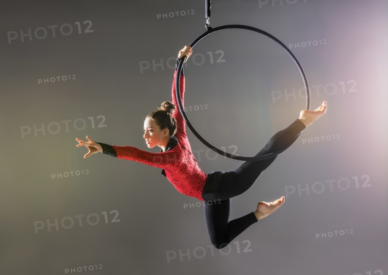 Teenage aerialist (14-15) practicing on gymnastics hoop