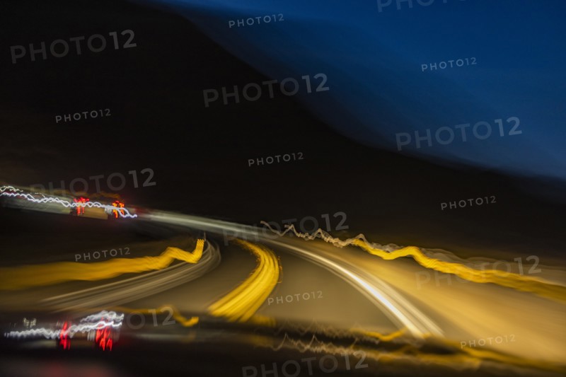 Blurred image of lights on highway at dusk