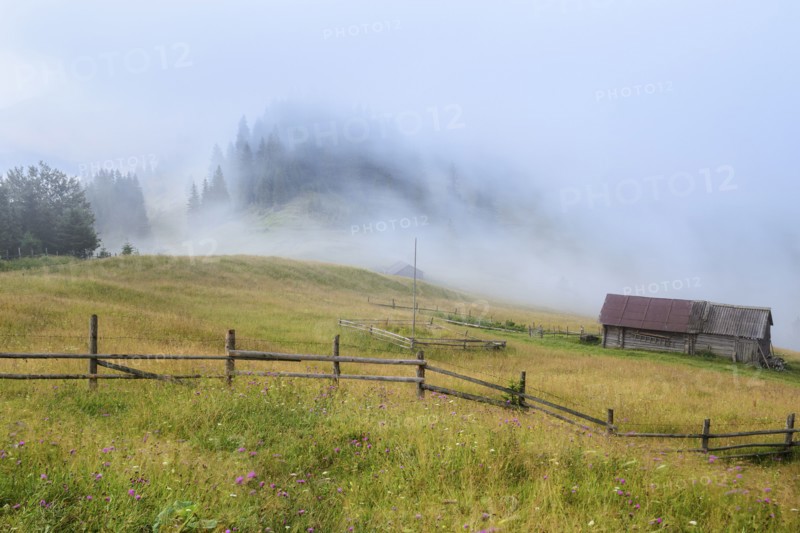 Foggy rural landscape in Carpathian Mountains