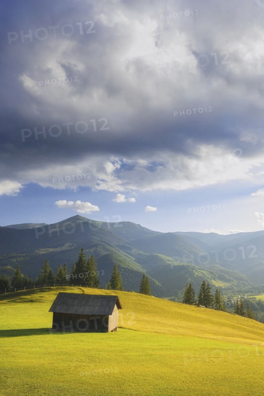 Wooden hut in rural landscape in Carpathian Mountains