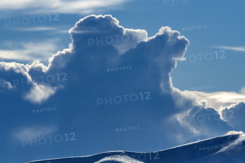 Backlit clouds in blue sky