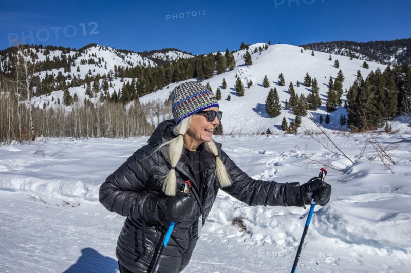 Senior female hiker hiking in mountains in winter