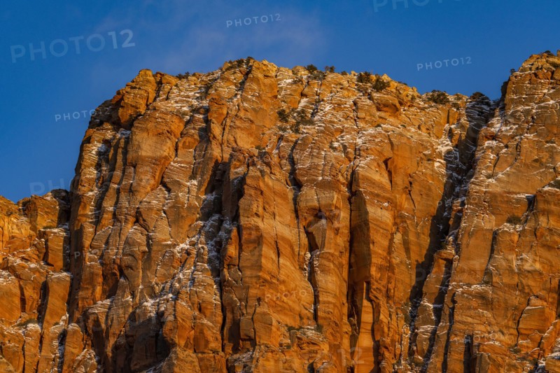 Blue sky above rough rocky mountain
