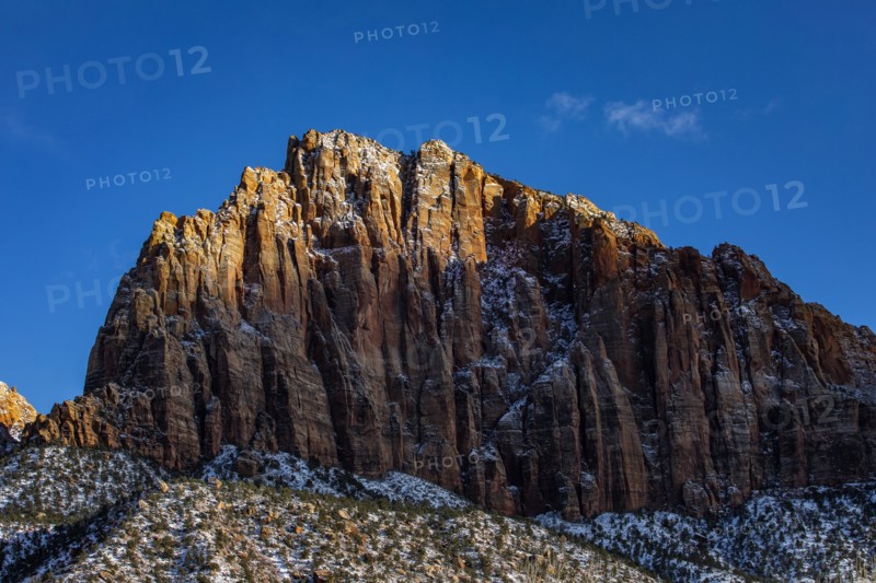 Scenic view of mountain peak against blue sky