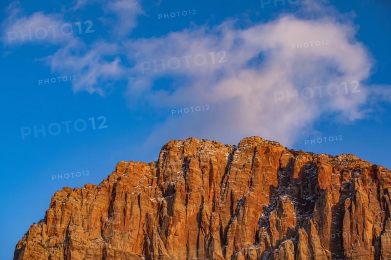 Scenic view of mountain peak against blue sky