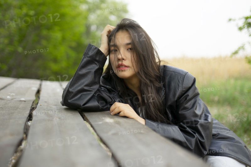 Portrait of teenage girl leaning on picnic table