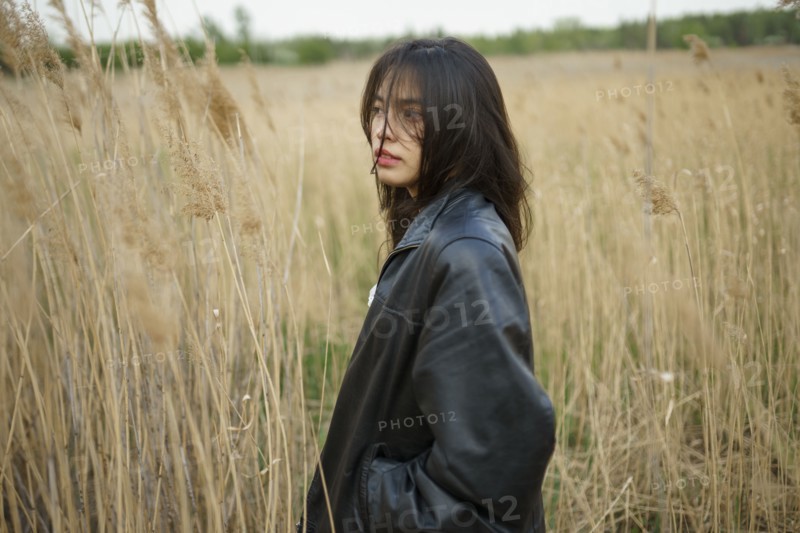 Portrait of teenage girl standing in field