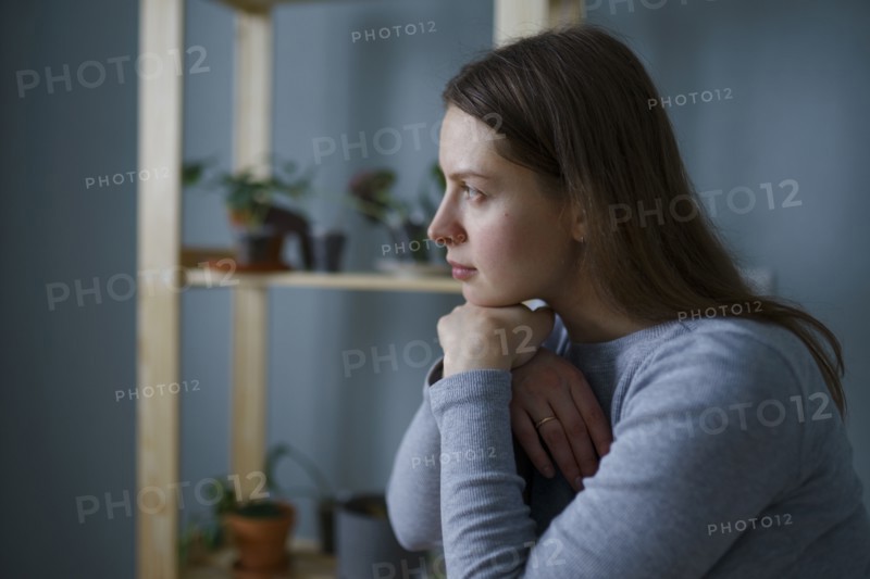 Portrait of thoughtful woman with hands on chin