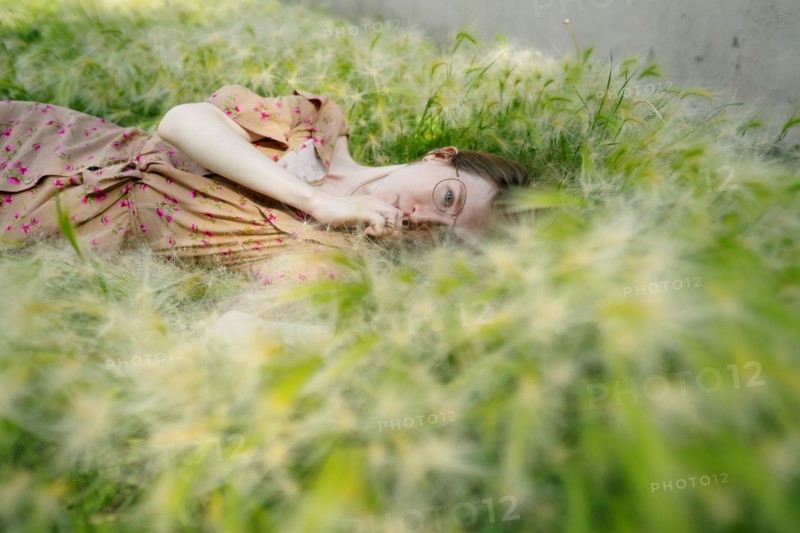 Portrait of woman lying on grass