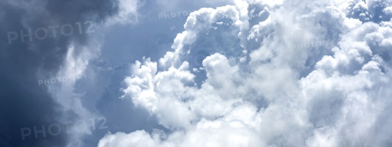 Puffy white and blue clouds on sky