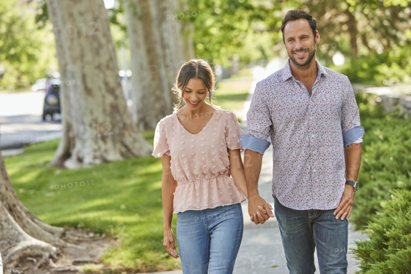 Smiling couple holding hands