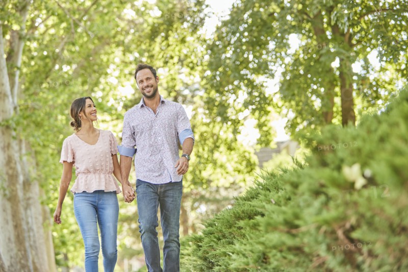 Smiling couple holding hands