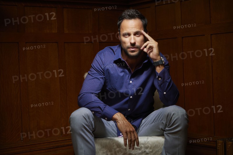 Portrait of mid adult man sitting on chair