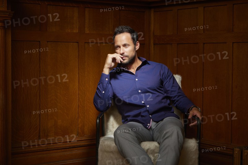 Mid adult man sitting on chair