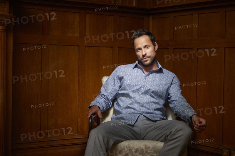 Portrait of mid adult man sitting on chair