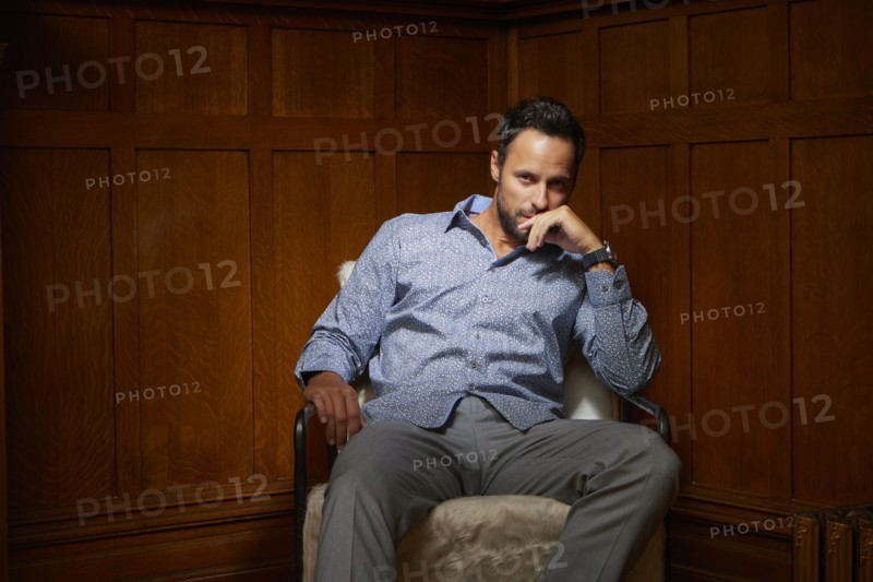 Portrait of mid adult man sitting on chair