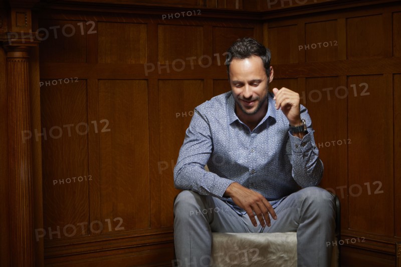 Smiling mid adult man sitting on chair