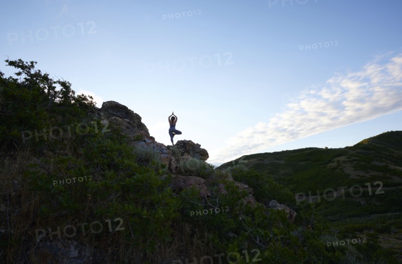 Mid adult woman doing yoga in mountains