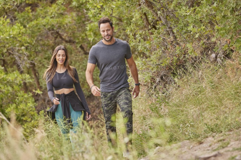 Mid adult couple hiking in forest