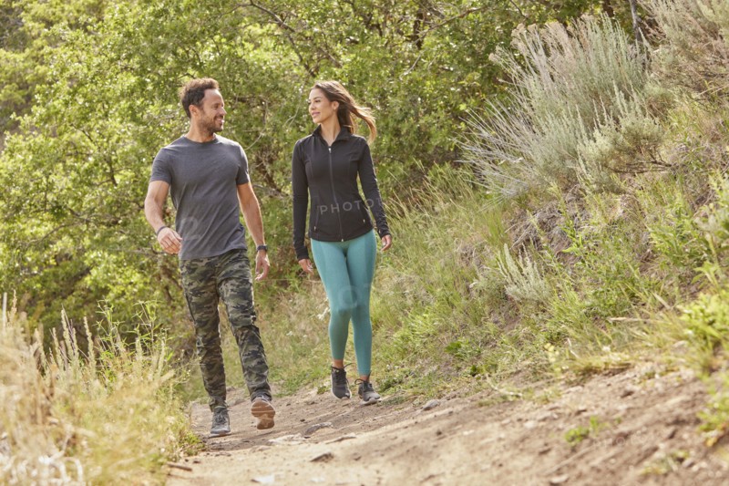 Mid adult couple hiking in forest