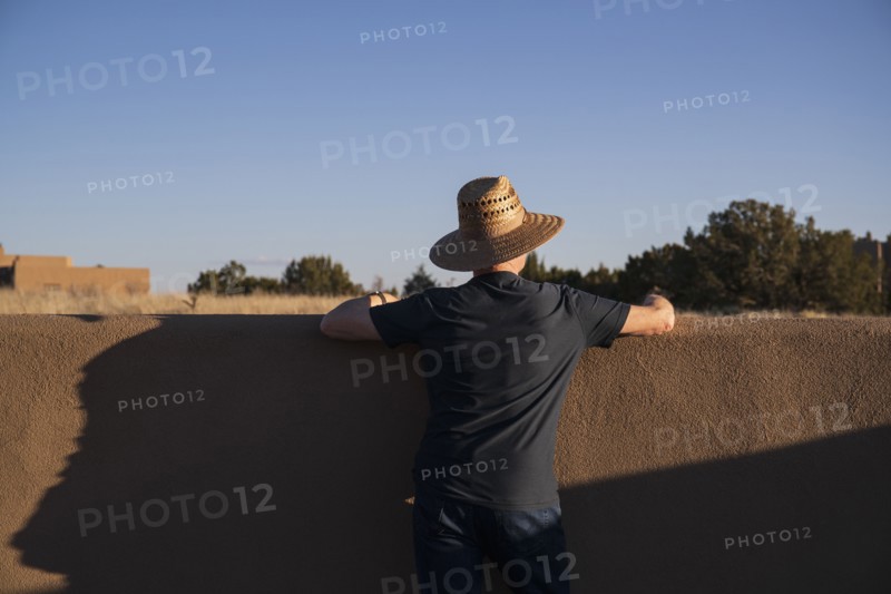 Rear view of man in hat looking at sky