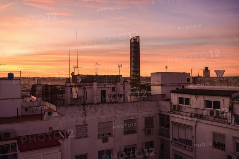 Modern skyscraper and old town architecture at sunset