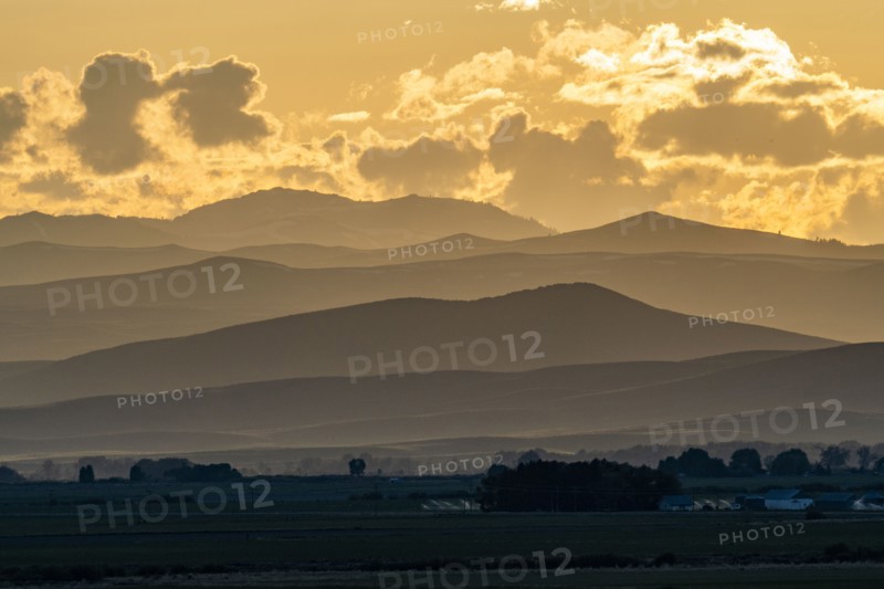 Clouds above mountains at sunset