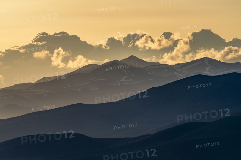 Clouds above mountains at sunset