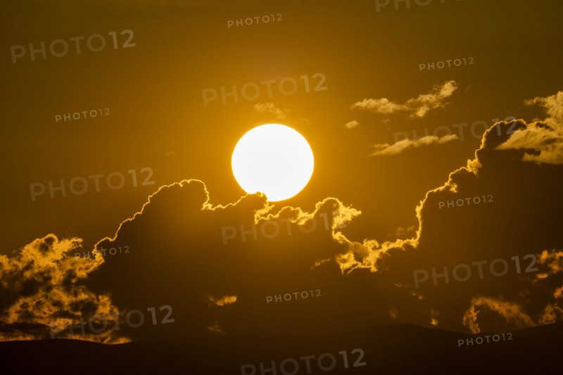 Sky with clouds and setting sun