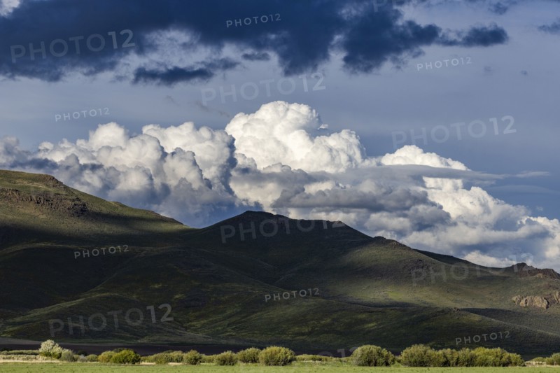 Majestic cumulus clouds above mountains