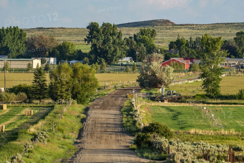 Rural landscape with dirt road leading to village