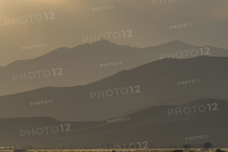 Mountain landscape in fog at sunset