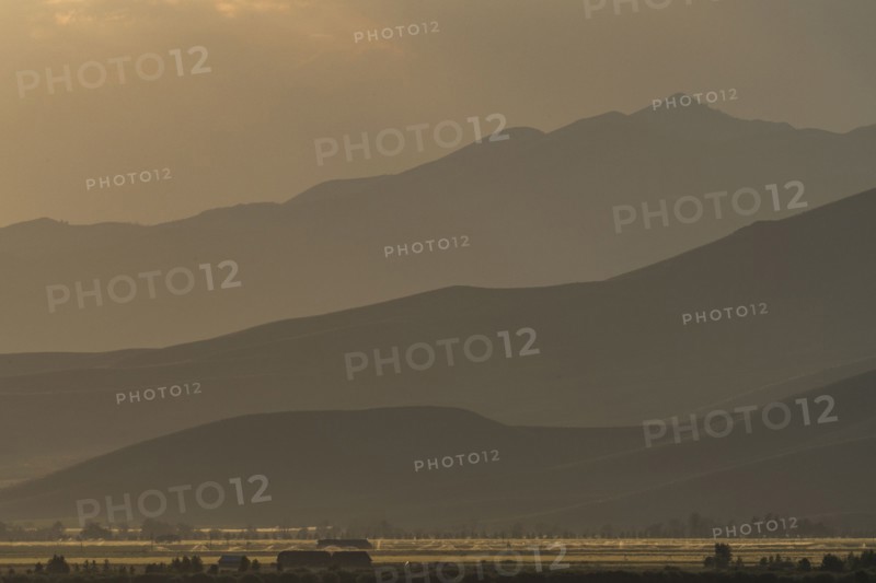 Mountain landscape in fog at sunset