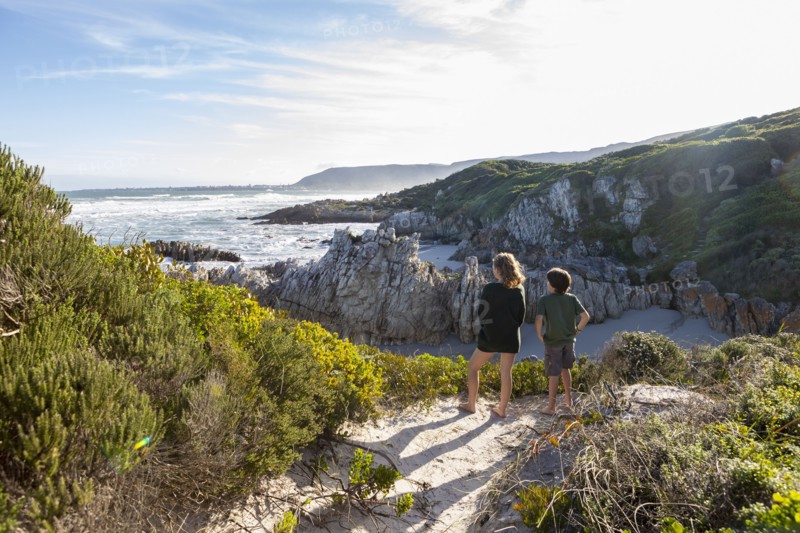 Brother and sister looking at Atlantic Ocean in Voelklip Beach