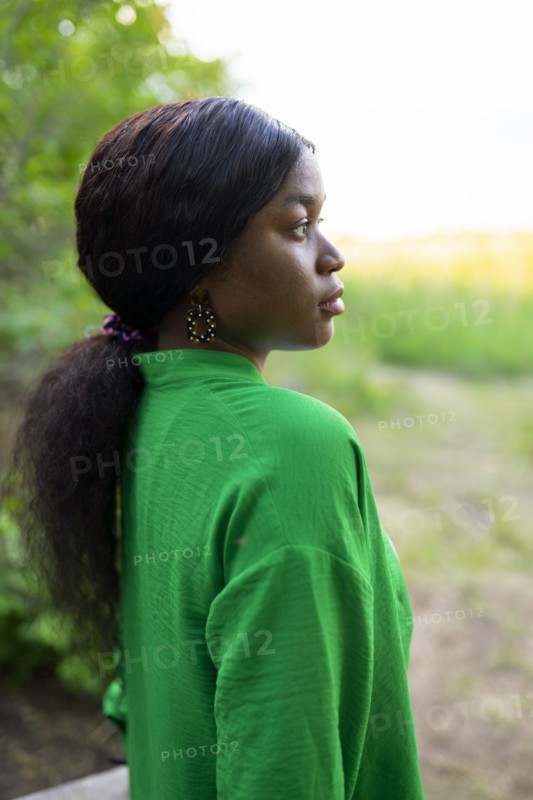 Side view of brunette woman wearing green blouse