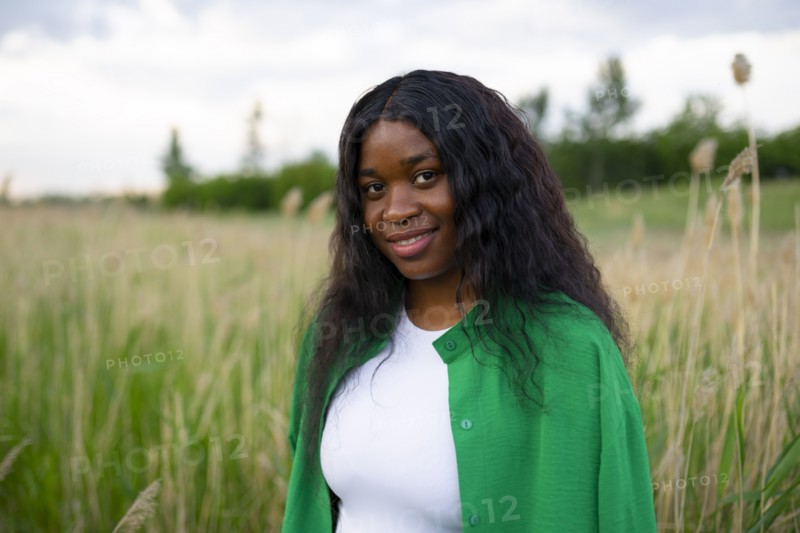 Portrait of smiling brunette in field