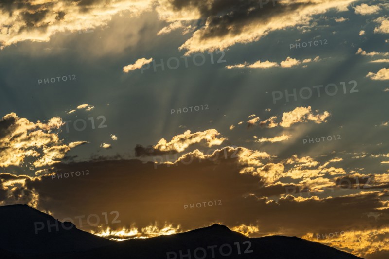 Silhouette of mountains with sunrise in background