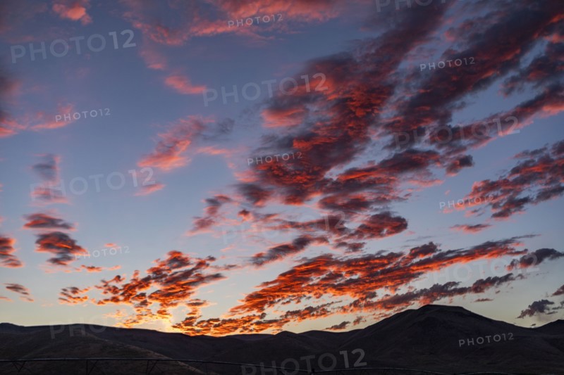 Silhouette of mountains with sunrise in background
