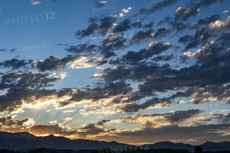 Silhouettes of mountains with sunrise in background