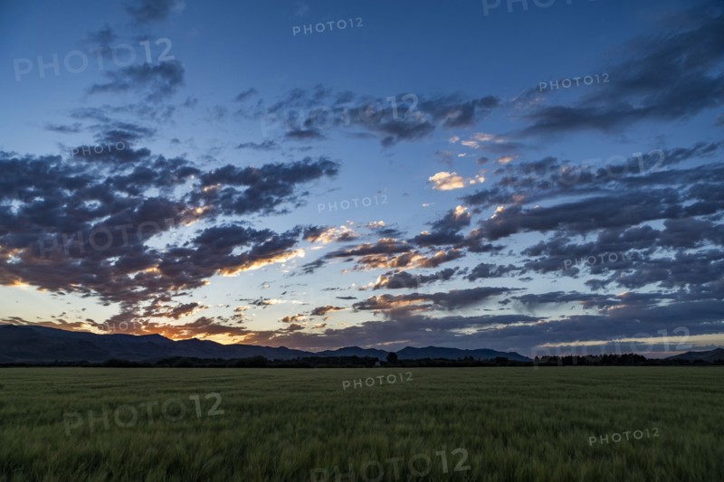 Sunrise over mountains and fields