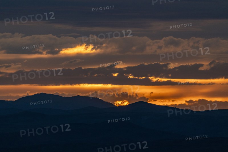 Beautiful sunset over silhouettes of mountains